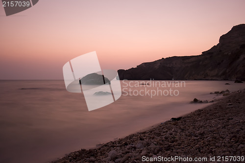 Image of Sunset sea rocky beach