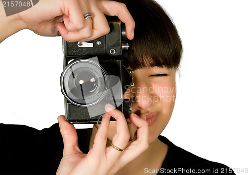 Image of Young beautiful smiling woman holding a photo camera