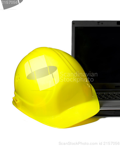 Image of Yellow Hard Hat on a laptop.Industrial concept