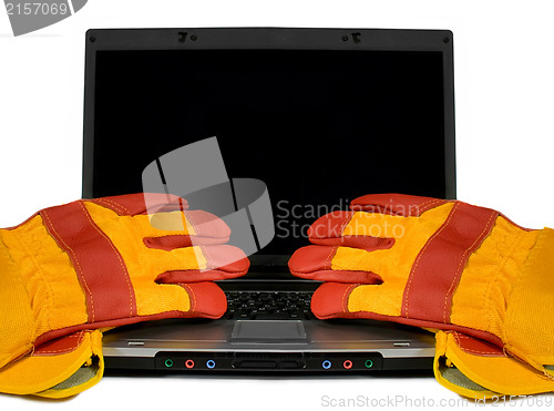 Image of Protective gloves on a laptop isolated. Empty black desktop for 