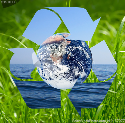 Image of Recycle symbol made from sea and grass photo