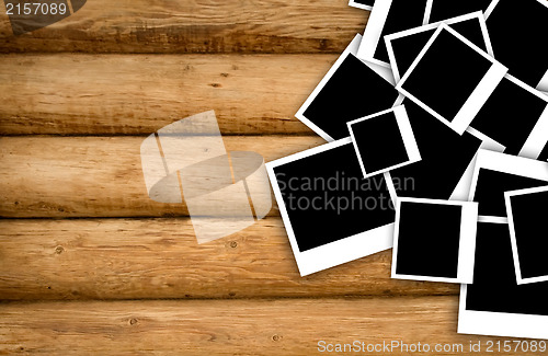 Image of Empty instant photos on grunge wood background