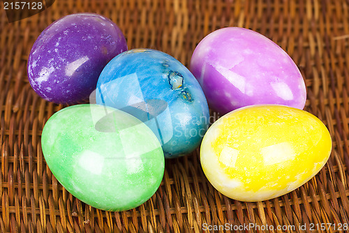 Image of Easter eggs in different colors on the braided surface