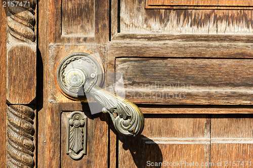 Image of Texture of old wooden door with a metal handle