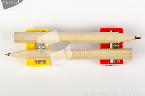 Image of Two wooden pencils with red and yellow pencil sharpeners