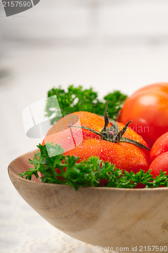 Image of tomatoes on a wood bowl