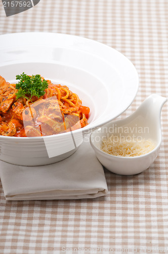 Image of Italian spaghetti pasta with tomato and chicken