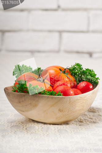 Image of tomatoes on a wood bowl