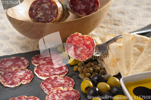 Image of cold cut platter with pita bread and pickles