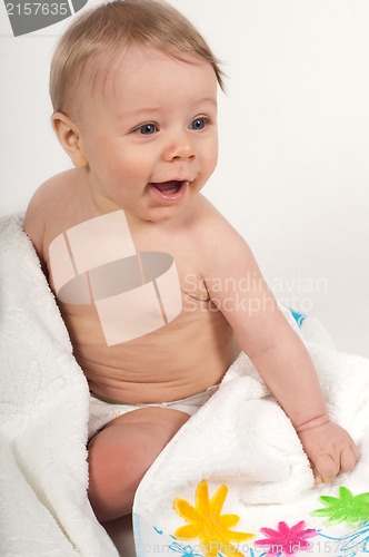 Image of Little boy in white blanket with flowers