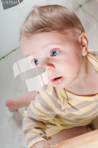 Image of Little cute baby boy in striped clothes