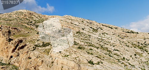 Image of Texture of a layered sedimentary rock under the blue sky