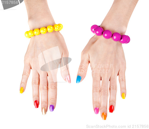 Image of Women's hands with a fashionable multi-colored nail polish with 