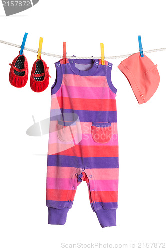 Image of A set of children's clothes hanging on a clothesline.