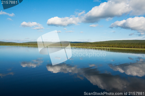 Image of Calm beautiful rural landscape with a lake and sky reflected