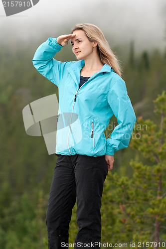 Image of beautiful girl looks into the distance