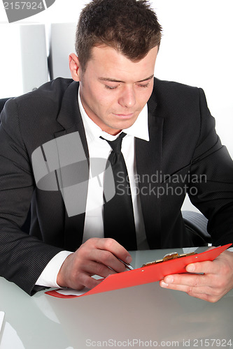 Image of Professional young man studying a file