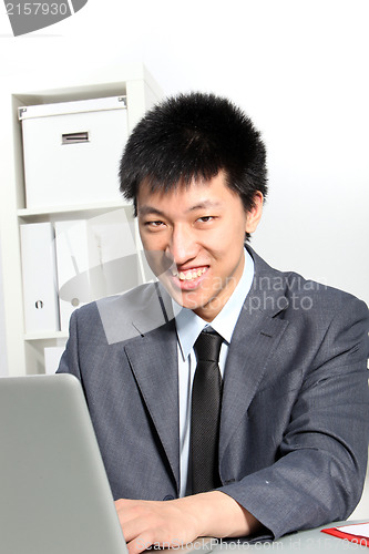 Image of Asian businessman working on computer