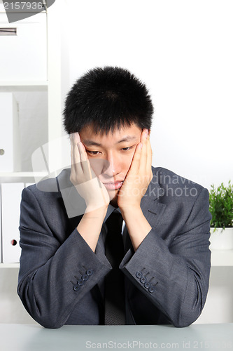 Image of Despondent Asian businessman