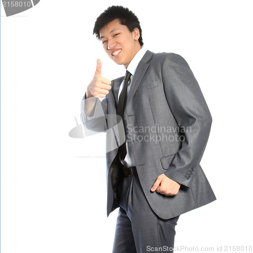 Image of Successful Asian businessman giving thumbs up