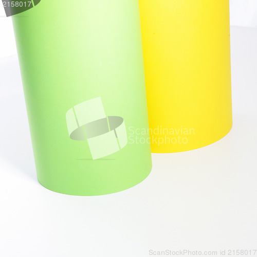 Image of Green and yellow rolls of cardboard