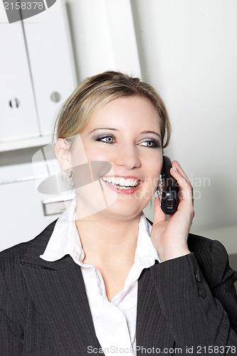 Image of Happy businesswoman talking on a mobile