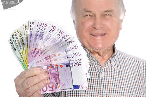 Image of Smiling senior man with a fistful of money