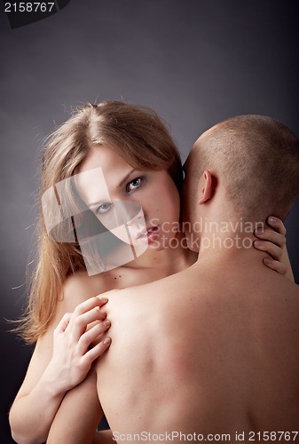 Image of Muscular man and topless girl