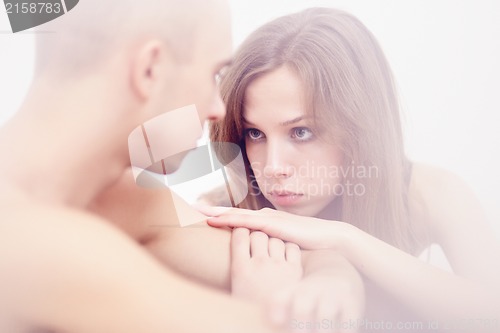 Image of Muscular man and topless girl