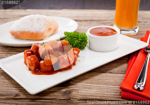 Image of curry wurst spicy sausage with curry and ketchup