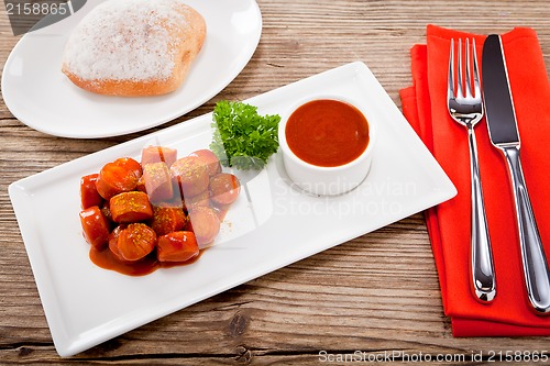 Image of curry wurst spicy sausage with curry and ketchup