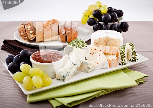Image of cheese plate with grapes and wine dinner