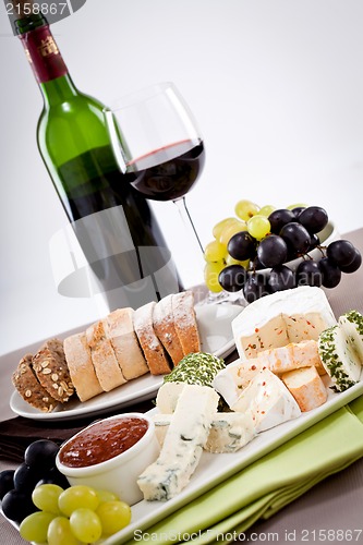 Image of cheese plate with grapes and wine dinner