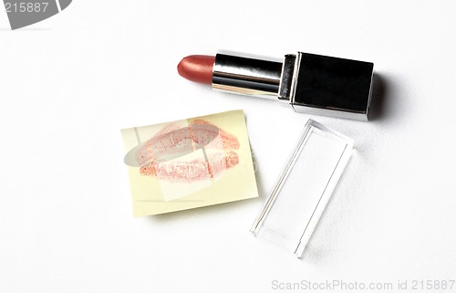 Image of red lipstick and yellow sticker note with kiss