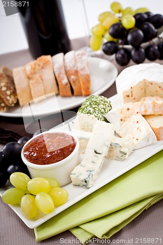 Image of cheese plate with grapes and wine dinner