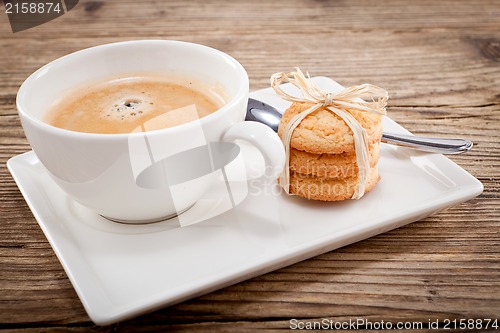 Image of fresh aromatic coffee and cookies on table