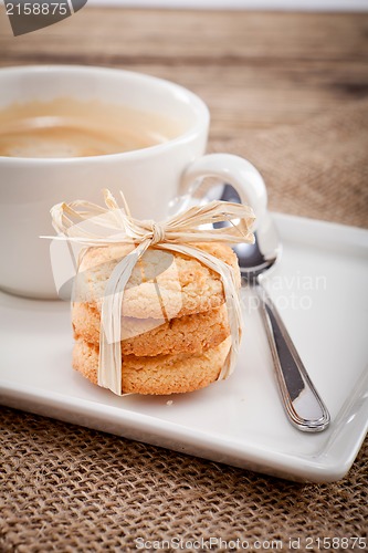 Image of fresh aromatic coffee and cookies on table