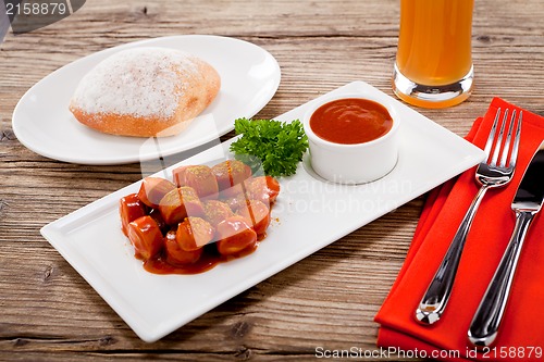 Image of curry wurst spicy sausage with curry and ketchup