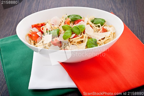 Image of fresh tasty pasta spaghetti with tomatoes and basil