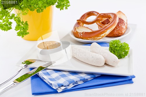 Image of weisswurst white sausages and sweet mustard with pretzel 