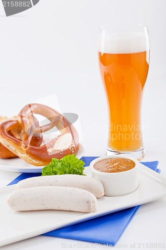 Image of weisswurst white sausages and sweet mustard with pretzel 