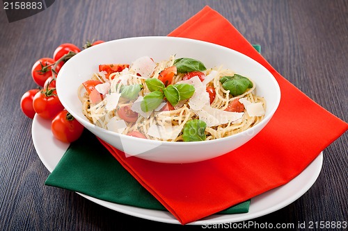 Image of fresh tasty pasta spaghetti with tomatoes and basil