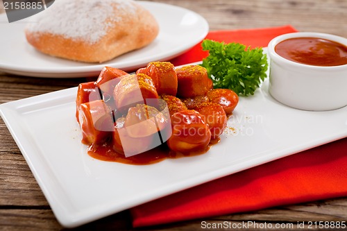 Image of curry wurst spicy sausage with curry and ketchup