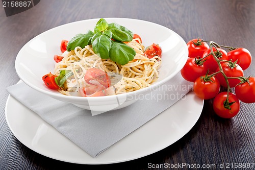 Image of fresh tasty pasta spaghetti with tomatoes and basil