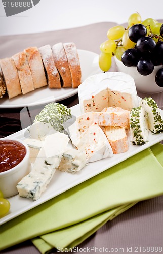 Image of cheese plate with grapes and wine dinner