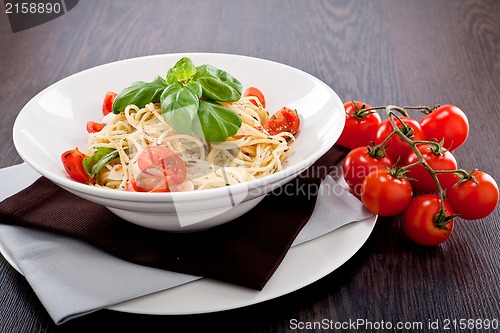 Image of fresh tasty pasta spaghetti with tomatoes and basil