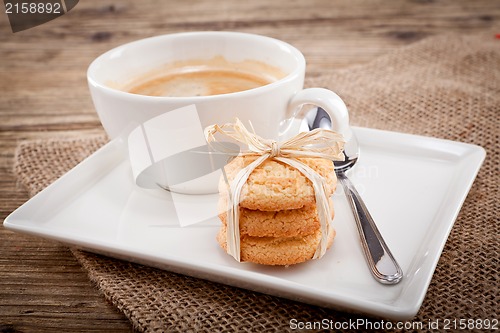 Image of fresh aromatic coffee and cookies on table