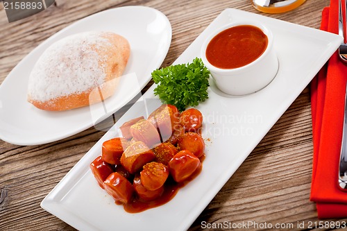 Image of curry wurst spicy sausage with curry and ketchup