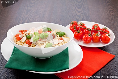 Image of fresh tasty pasta spaghetti with tomatoes and basil