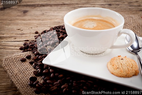 Image of fresh aromatic coffee and cookies on table